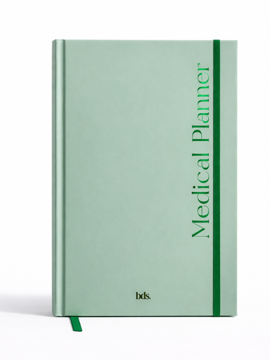 Green hardcover medical planner with vertical text, "Medical Planner," and a matching green elastic band