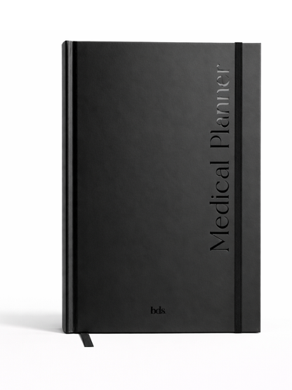 Black hardcover journal titled "Medical Planner" with a vertical elastic band closure. Features a sleek, minimalist design and a ribbon bookmark.